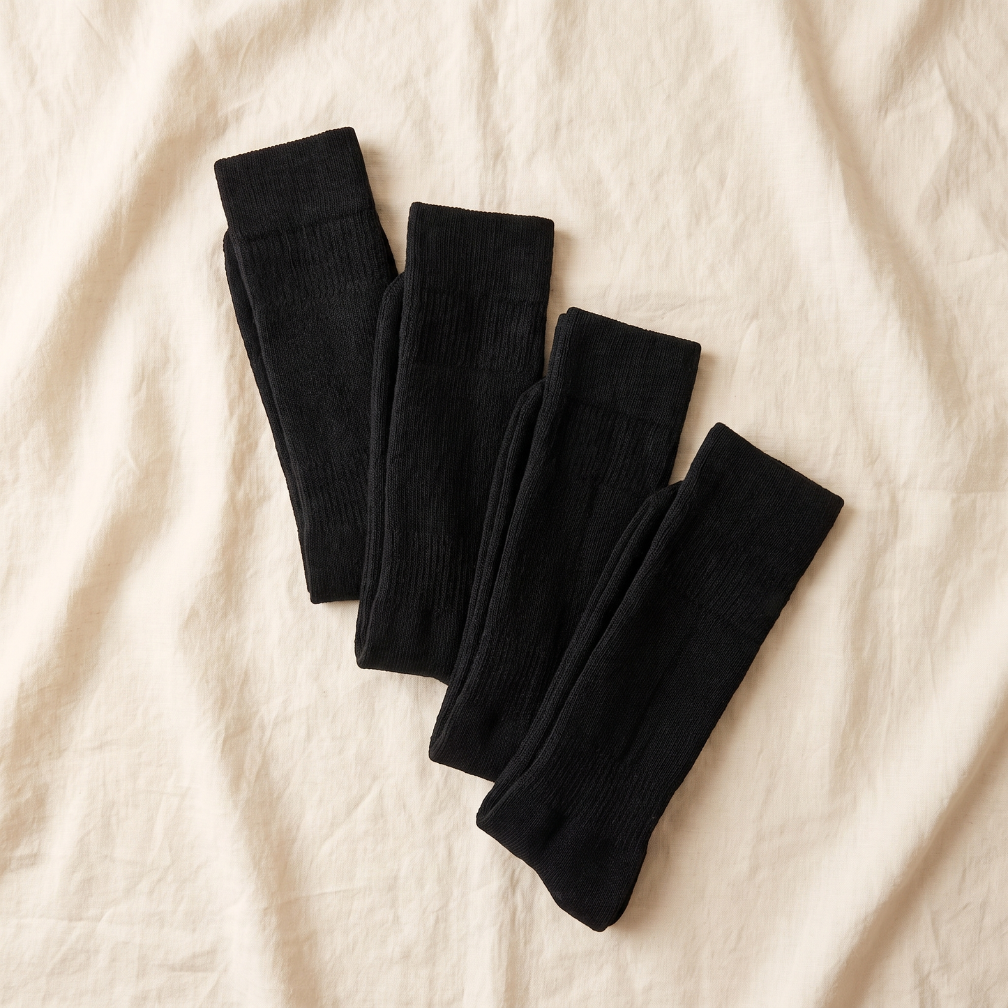 Hunt Bundle flat lay - 4 pairs of over the calf hunting socks folded on cream linen