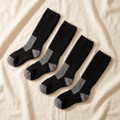 Ski and Snow Bundle flat lay - 4 pairs of over the calf ski socks folded on cream linen